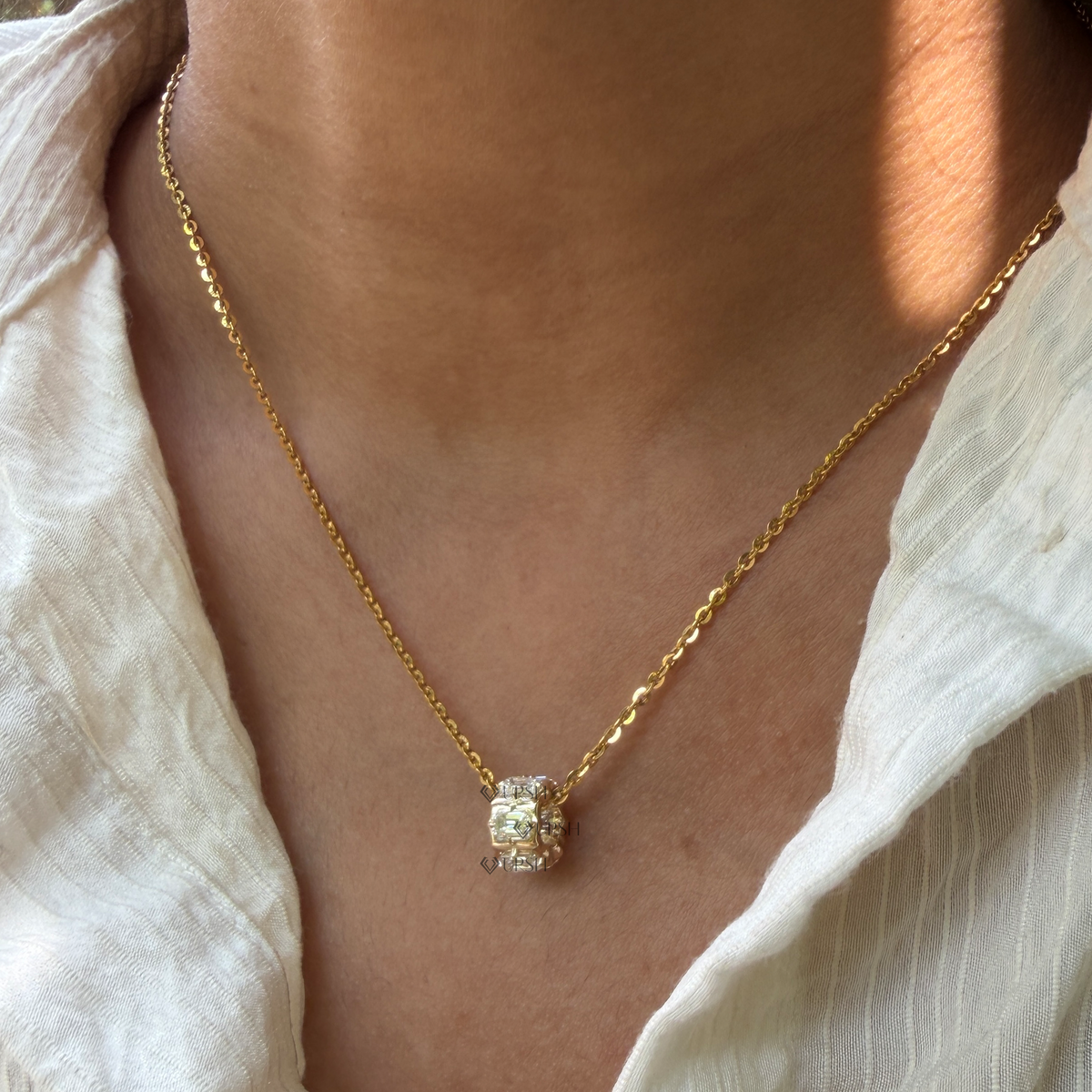 Yellow gold emerald cut diamond barrel bead spacer pendant necklace styled gracefully on neck in natural daylight