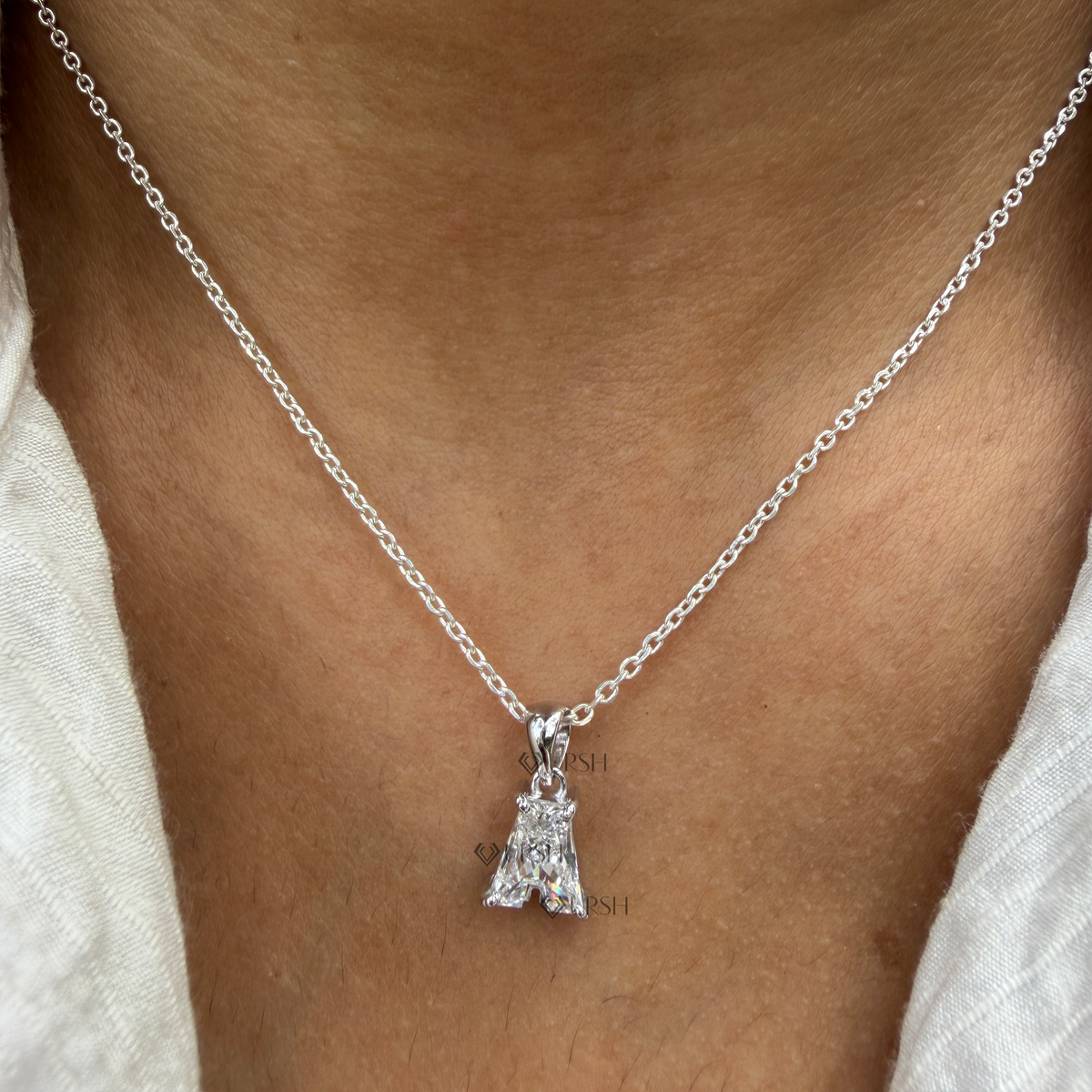 Daylight perspective view of white gold letter A diamond initial pendant necklace worn on neck
