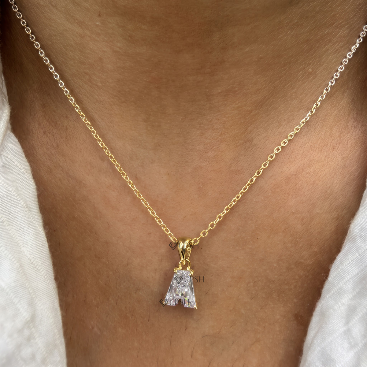 Daylight angle view of yellow gold letter A initial diamond pendant chain worn along collarbone