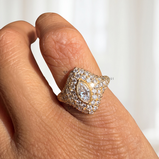 Solid yellow gold marquise diamond pave signet ring worn on woman's pinky finger.