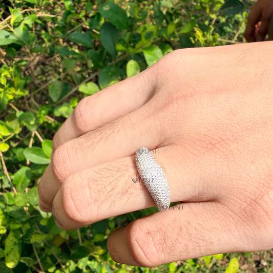 Chunky tapered pavé dome ring styled gracefully on finger in natural daylight showcasing bold volume