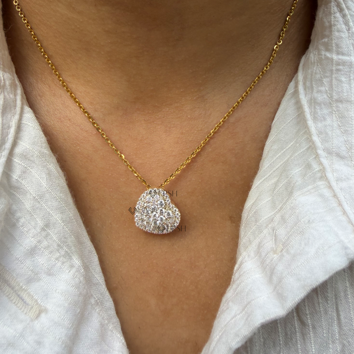 Yellow gold pavé diamond heart cluster pendant necklace styled gracefully on neck in natural daylight
