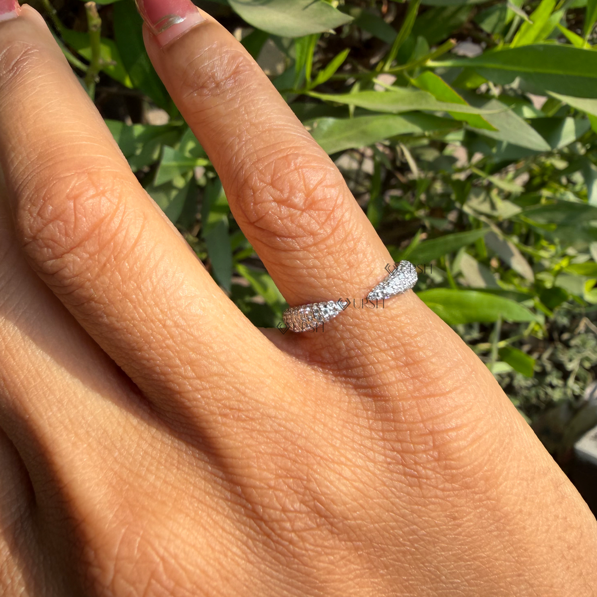 Daylight angle view of open gap diamond ring worn on hand showcasing sleek bypass silhouette