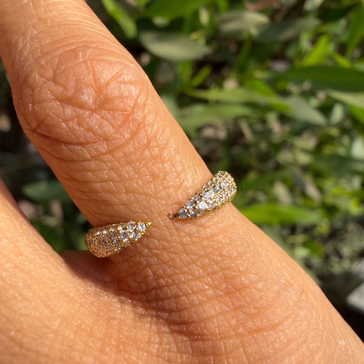 Pavé diamond open gap statement ring styled gracefully on finger in natural daylight