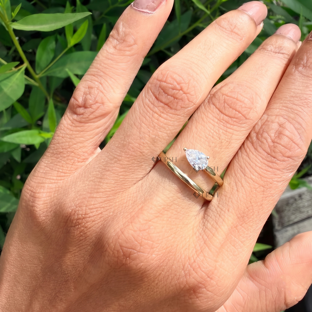 Daylight angle view of spiral wrap diamond ring worn on hand showcasing coil silhouette