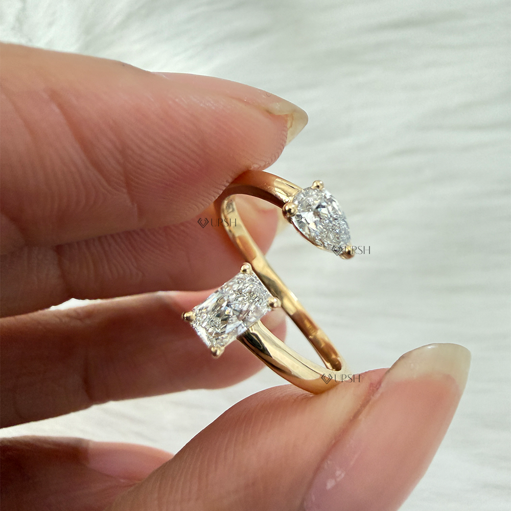Holding yellow gold spiral bypass ring displaying open profile and stone orientation