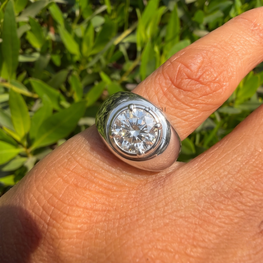 Daylight close-up of chunky dome solitaire ring worn on finger highlighting heavy gold polish
