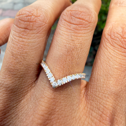 V-shaped diamond curved chevron stacking band worn on finger in natural sunlight