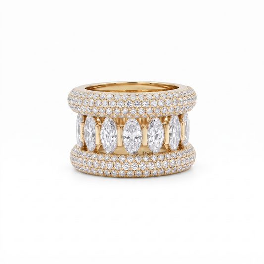 A yellow gold ring featuring a double-row pavé setting with marquise-cut clear gemstones in the center and smaller round stones around the band, shown on a plain white background.
